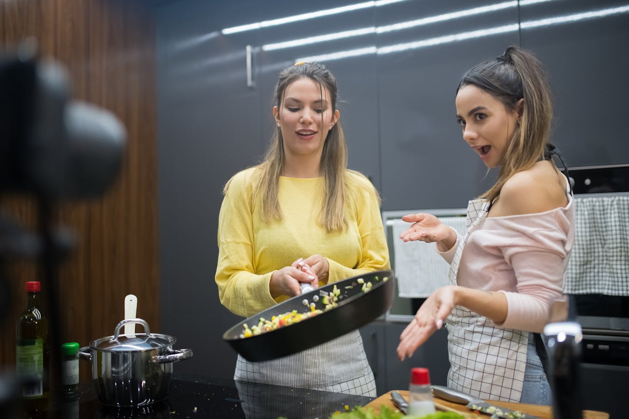 Smiling home chef livestreaming a cook-along from her kitchen