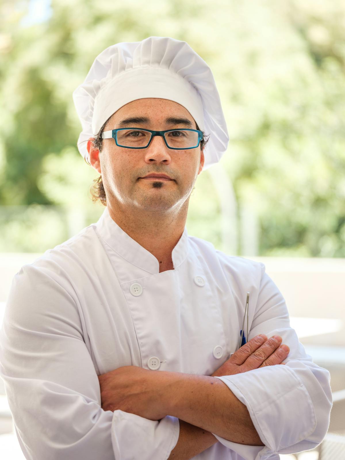 A Black chef carefully finishing a dish